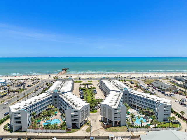 birds eye view of property with a water view and a view of the beach