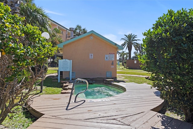 view of pool featuring a community hot tub and a deck