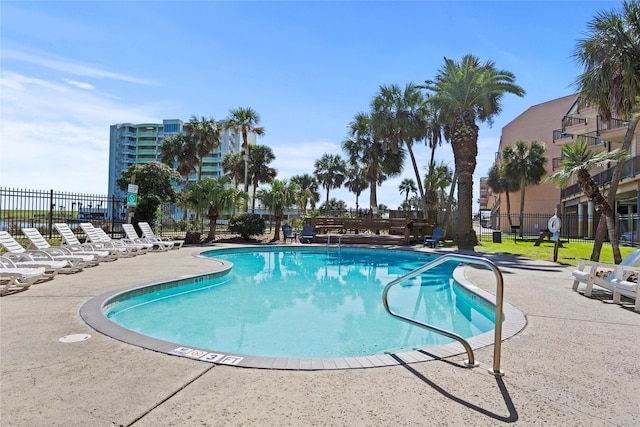 community pool featuring a patio area and fence