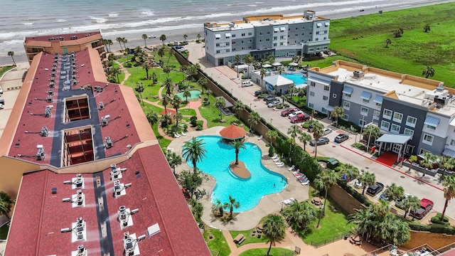 birds eye view of property with a beach view and a water view