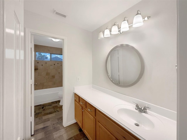 full bathroom with visible vents, vanity, and toilet