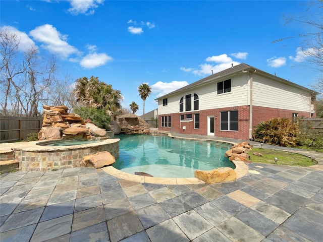 view of swimming pool with an in ground hot tub, a patio, fence, and a fenced in pool