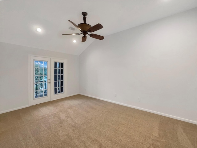 spare room with baseboards, lofted ceiling, carpet flooring, french doors, and recessed lighting