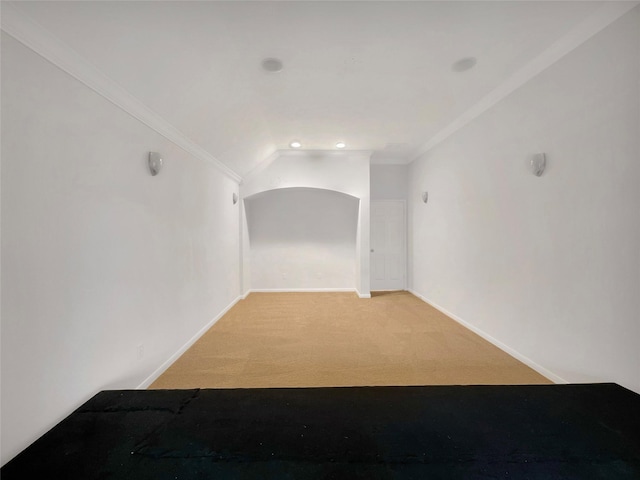 unfurnished room featuring light carpet, ornamental molding, and baseboards