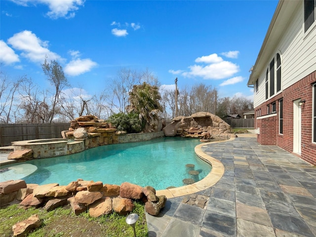 view of swimming pool featuring a fenced in pool, a patio area, a fenced backyard, and an in ground hot tub