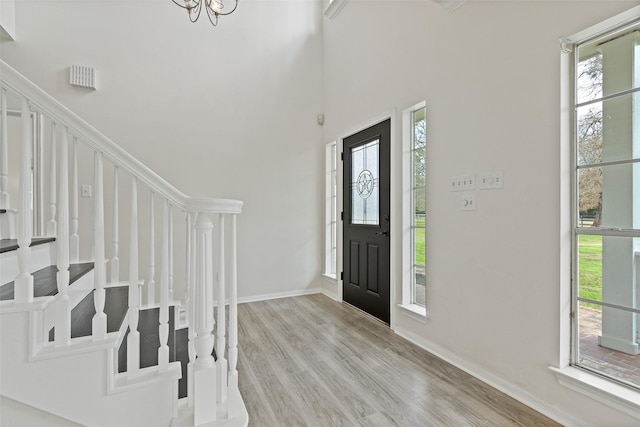 entryway featuring stairway, plenty of natural light, and wood finished floors