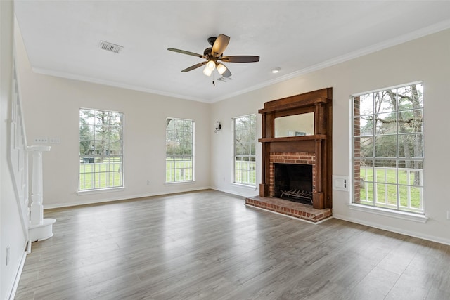 unfurnished living room with ornamental molding, a ceiling fan, and wood finished floors