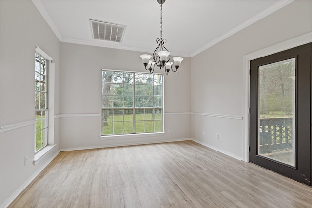 unfurnished room with visible vents, wood finished floors, a healthy amount of sunlight, and a chandelier