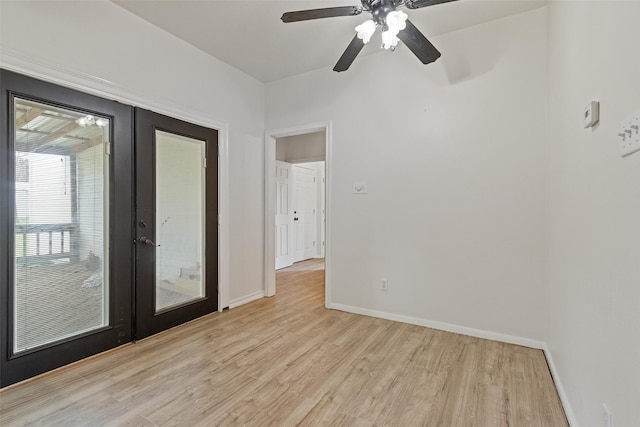 unfurnished room with french doors, a ceiling fan, light wood-type flooring, and baseboards