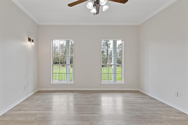 spare room featuring a healthy amount of sunlight, light wood-type flooring, a ceiling fan, and ornamental molding