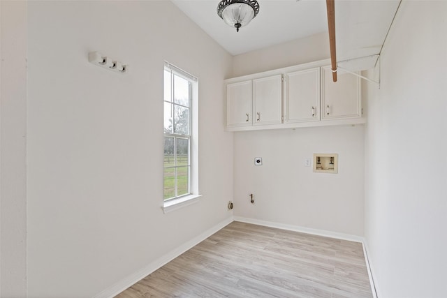 laundry area with light wood-style flooring, cabinet space, baseboards, hookup for an electric dryer, and hookup for a washing machine