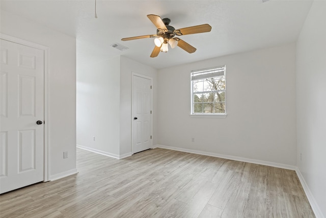 unfurnished room with visible vents, baseboards, and light wood-style floors