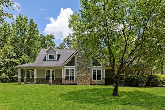 view of front of property featuring stone siding and a front yard