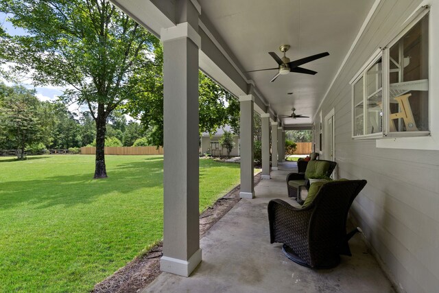 view of patio featuring ceiling fan and fence