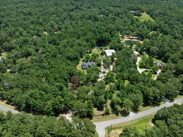 birds eye view of property featuring a wooded view