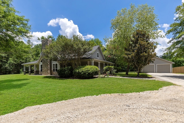 view of front of home featuring an outbuilding, a chimney, and a front yard