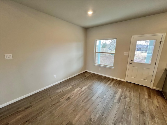 entrance foyer featuring baseboards and dark wood finished floors