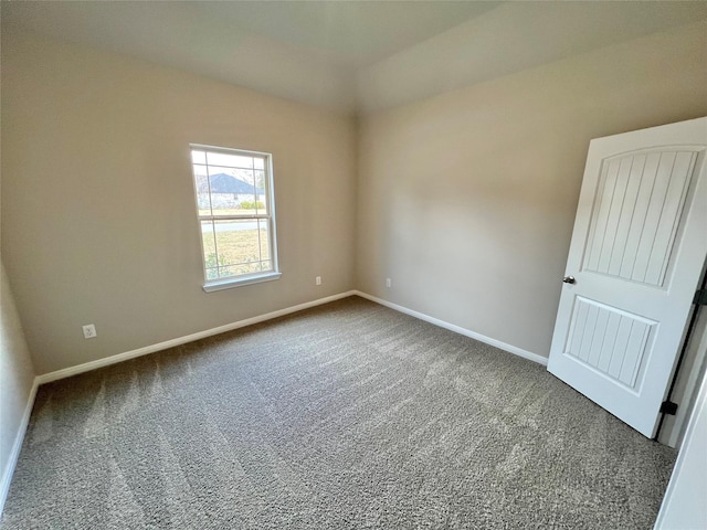 spare room with carpet and baseboards