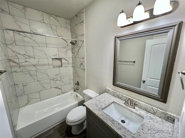 full bathroom featuring toilet, shower / bath combination, wood finished floors, and vanity