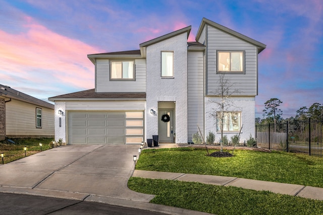 view of front of home featuring a garage, concrete driveway, fence, a front lawn, and brick siding