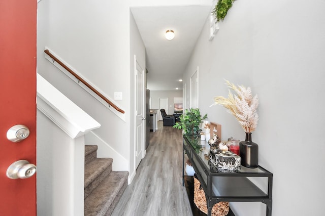 entryway featuring stairway and light wood-style floors