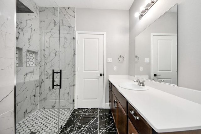 bathroom featuring marble finish floor, vanity, and a marble finish shower