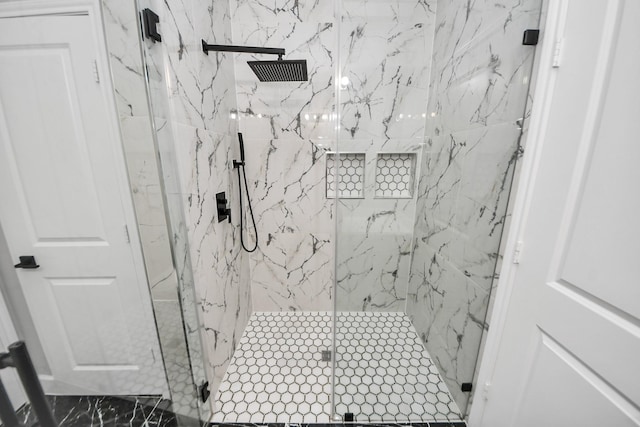 full bathroom featuring a marble finish shower