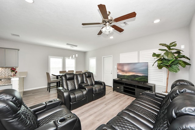 living area with recessed lighting, visible vents, ceiling fan, light wood-type flooring, and baseboards