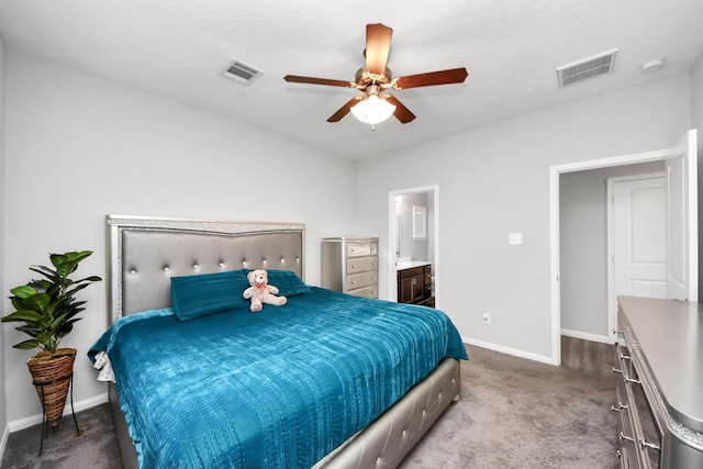 carpeted bedroom with visible vents, ceiling fan, baseboards, and ensuite bathroom