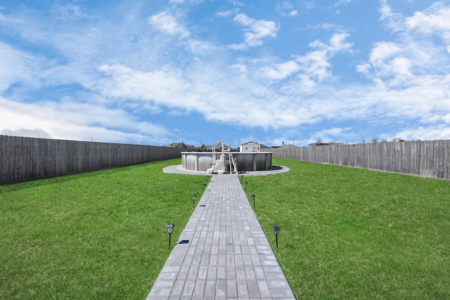 view of yard featuring a fenced in pool and a fenced backyard