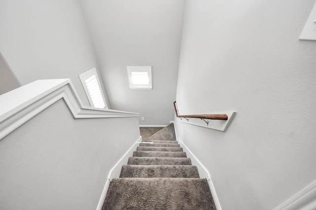 stairway featuring carpet and baseboards