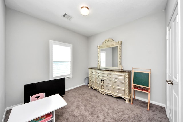 carpeted bedroom featuring visible vents and baseboards