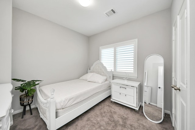 bedroom with baseboards, visible vents, and carpet flooring