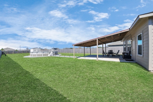 view of yard featuring a patio area, a fenced backyard, and a fenced in pool