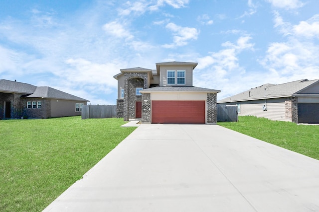 prairie-style house featuring a garage, a front yard, fence, and driveway