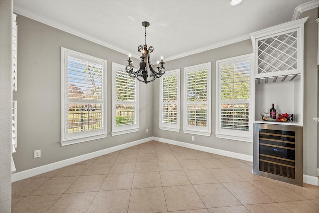 unfurnished dining area featuring baseboards, wine cooler, crown molding, a notable chandelier, and light tile patterned flooring