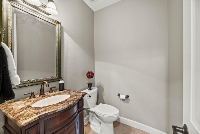 half bathroom featuring toilet, tile patterned flooring, baseboards, and vanity