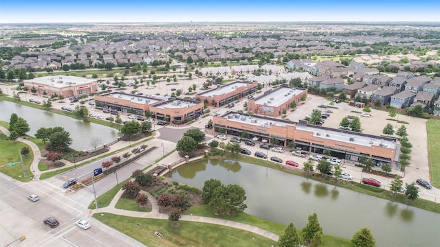 drone / aerial view featuring a water view and a residential view