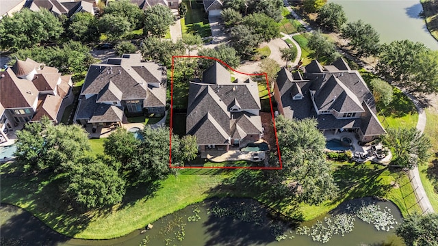 drone / aerial view featuring a water view and a residential view