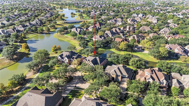 birds eye view of property with a water view and a residential view