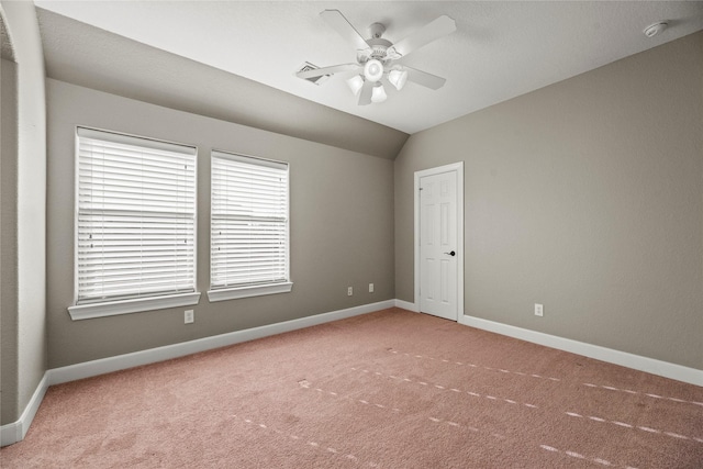 unfurnished room with ceiling fan, carpet, baseboards, and vaulted ceiling