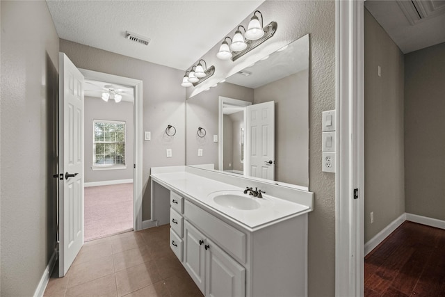 bathroom featuring visible vents, vanity, baseboards, and tile patterned floors