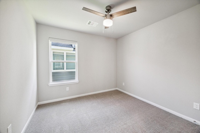 unfurnished room with visible vents, carpet flooring, baseboards, and ceiling fan