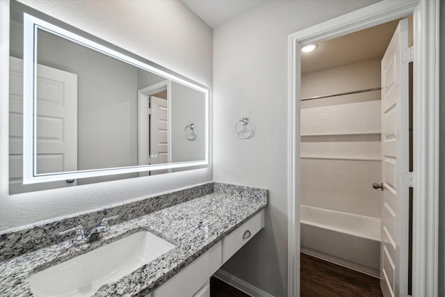 full bathroom with vanity, bathing tub / shower combination, and wood finished floors