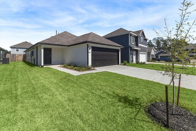 view of front of property with a front lawn, fence, concrete driveway, a garage, and central AC unit