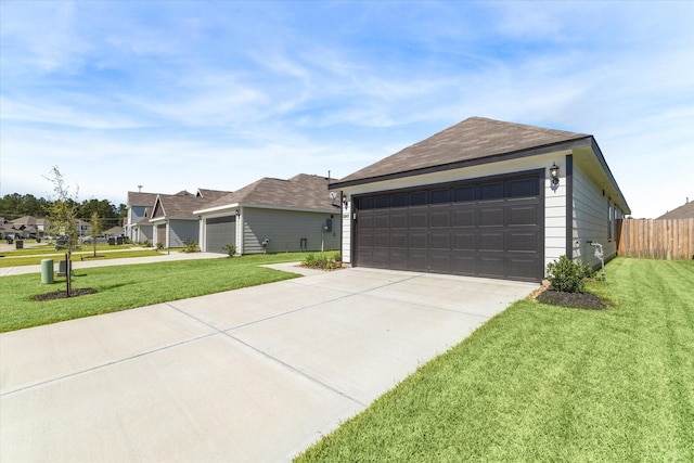 view of front facade featuring a garage, a front yard, and fence