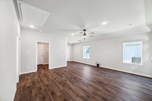 spare room featuring dark wood-style floors, visible vents, baseboards, and ceiling fan