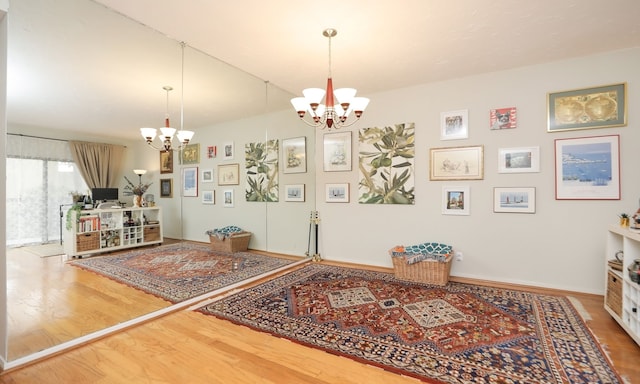 interior space with a chandelier, baseboards, and wood finished floors