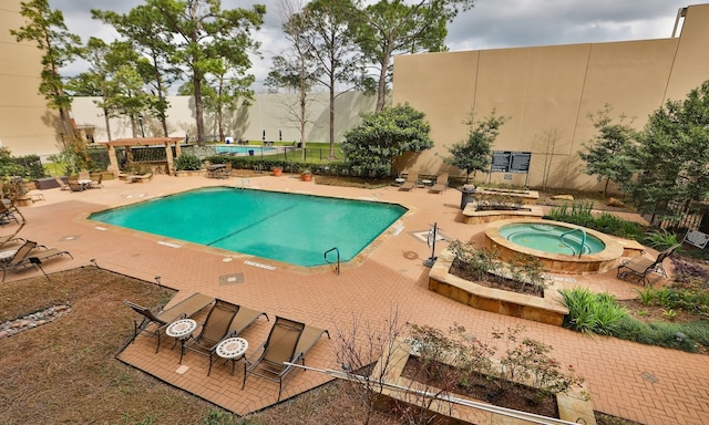 community pool featuring a community hot tub and a patio