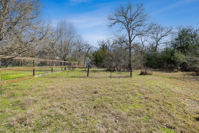 view of yard featuring a rural view and fence